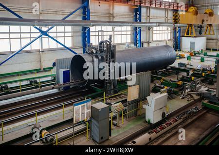 Longitudinal tack welding machine for welding of outer seam of steel pipe. Stock Photo