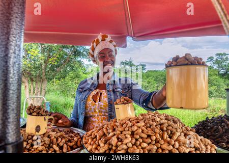 street vendor african woman selling peanuts and mopane worms Stock Photo