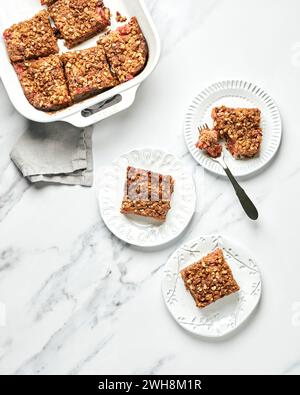 Strawberry Rhubarb Crumb Bars on White Plates Stock Photo