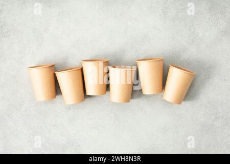 Flat lay composition with eco-friendly paper cups on grey stone background. Zero waste packaging concept Stock Photo
