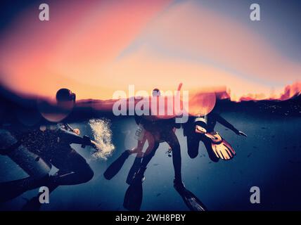 The beauty of the underwater world - divers come out of the water after a long dive - split photo - scuba diving in the Red Sea, Egypt. Stock Photo