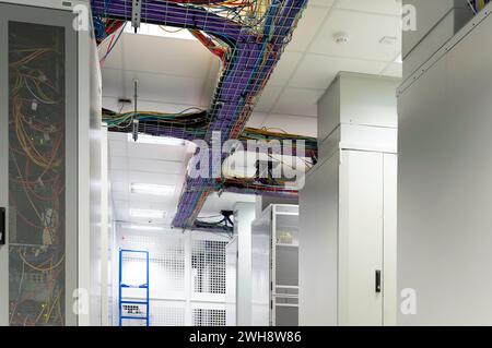 overhead racking with lots of network cables Stock Photo