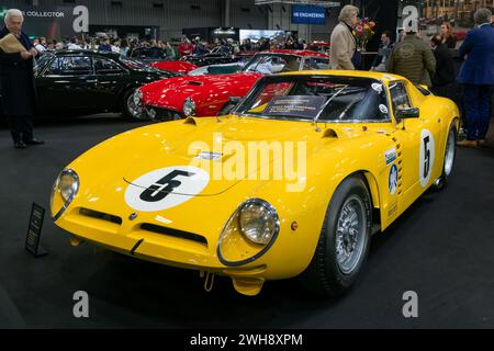 Paris, France - Rétromobile 2024. Focus on a yellow 1965 Bizzarrini 5300 GT Strada. Stock Photo