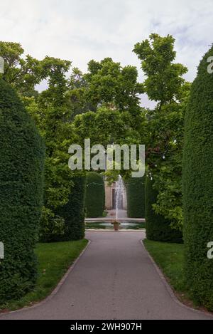 Tranquil Park Oasis: Fountain Amidst Scenic Landscapes. Urban Oasis- Majestic Fountain Amidst Lush Parkland. Splendid Fountain Gracing City Park Stock Photo