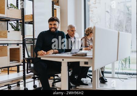 Multicultural team of diverse employees collaborating in a modern co working space Stock Photo