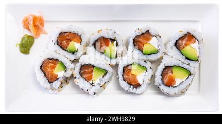 On table there is plate with set of sushi - uramaki rolls california roll with chees Stock Photo