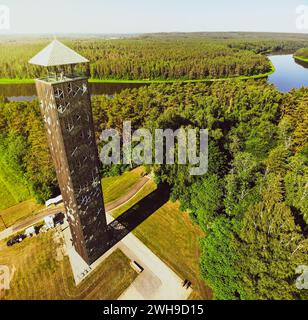 Tourist stand on top look out Birstonas observation tower - highest such tower in Lithuania. Drone aerial outdoors summer landscape view Nemunas panor Stock Photo