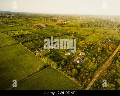 Houses in a rural village by Westport tow near the Irish Atlantic Coast.Greenery and real estate in Ireland concept. Agriculture and irish landscapes Stock Photo