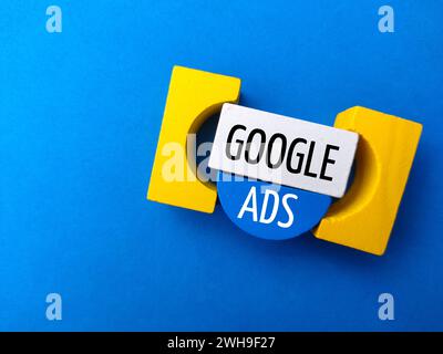 Top view colored block with text GOOGLE ADS on a blue background. Stock Photo
