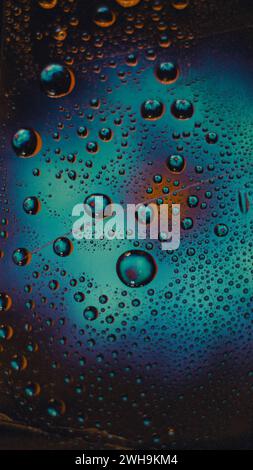 Abstract blue textured background, drops of azul water on tape with reflection of a flower in drops. Stock Photo