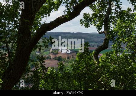 Bad Munster, Germany - May 12, 2021: Rheingrafenstein through trees on a hill in Rhineland Palatinate, Germany on a spring day. Stock Photo