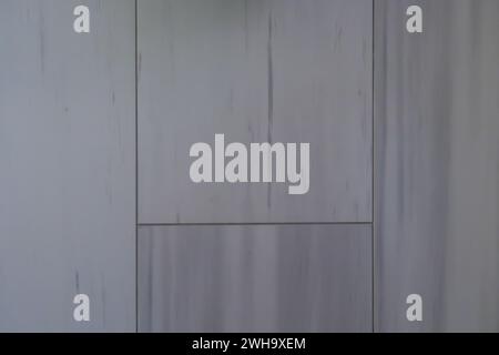 Abstract texture background of a large stone tiled shower wall surface with blue color striations Stock Photo
