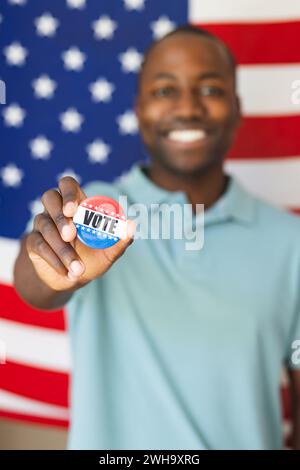 Young African American man shows a 'vote' badge proudly, with copy space Stock Photo