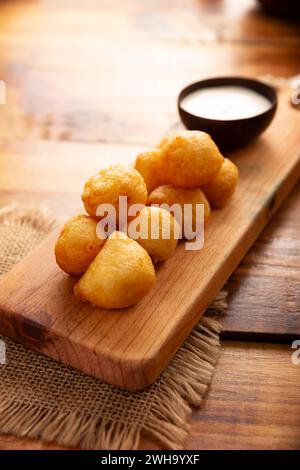 Fried breaded cheese balls, easy and delicious homemade snack recipe. Served with dipping sauce. Stock Photo