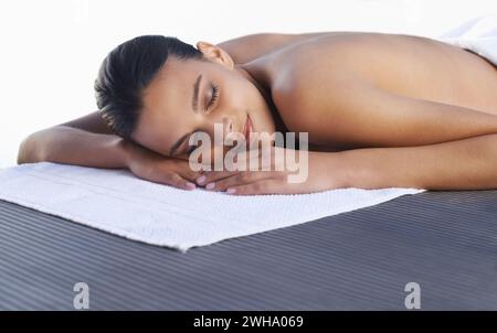 Spa, sleeping or face of woman ready for luxury treatment, facial skincare or beauty for wellness. Towel, healing therapy or zen female client on bed Stock Photo