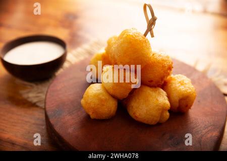 Fried breaded cheese balls, easy and delicious homemade snack recipe. Served with dipping sauce. Stock Photo