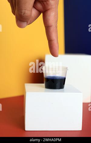 Celup Tinta Pemilu, Concept Indonesia Election Day. Inked Finger for Vote Stock Photo