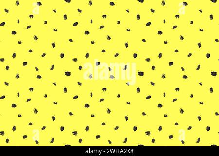 Dash pattern on yellow background. Wrapping paper with small black dots painted with a brush. Seamless simple minimal ornament. Abstract geometric Stock Vector