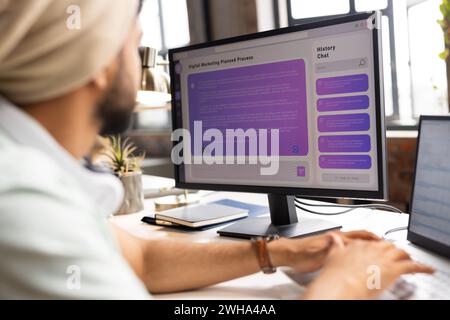 Young Asian man works on a computer in a casual business office Stock Photo