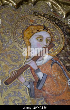 angel with medieval transverse flute, Mother of God of humility with musical angels altarpiece, Francesc Comes, 1390-94, Parish of La Mare de Deu dels Stock Photo
