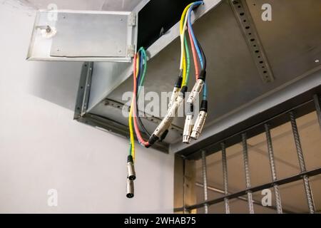 Colored wires hanging from the ceiling close up Stock Photo