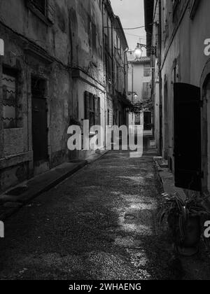 Arles, France - March 7, 2023: Empty street in the center of Arles (France) in the night, black and white Stock Photo