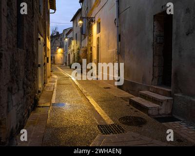 Arles, France - March 7, 2023: Empty street in the center of Arles (France) in the night, street lamps Stock Photo