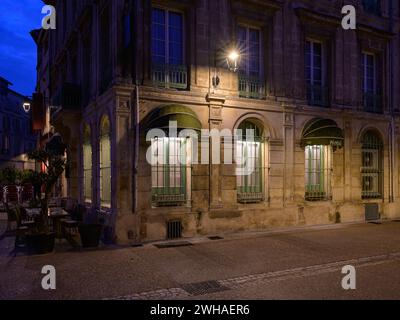 Arles, France - March 7, 2023: Empty street in the center of Arles (France) in the night, streetlamp on a hotel Stock Photo