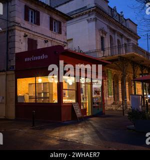 Arles, France - March 7, 2023: Empty street in the center of Arles (France) in the night, front of a bar Stock Photo