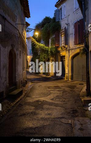 Arles, France - March 7, 2023: Empty street in the center of Arles (France) in the night, plants growing on facade Stock Photo