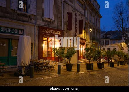 Arles, France - March 7, 2023: Empty street in the center of Arles (France) in the night, shops Stock Photo