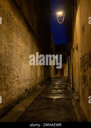 Arles, France - March 7, 2023: Empty street in the center of Arles (France) in the night Stock Photo