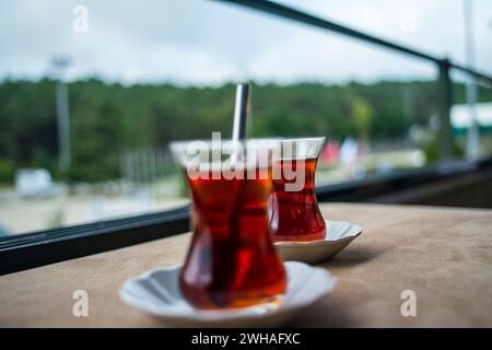 Two Turkish tea cups, a warm and aromatic duo, capturing the essence of Turkish tea culture and hospitality in a cozy and traditional setting. Stock Photo