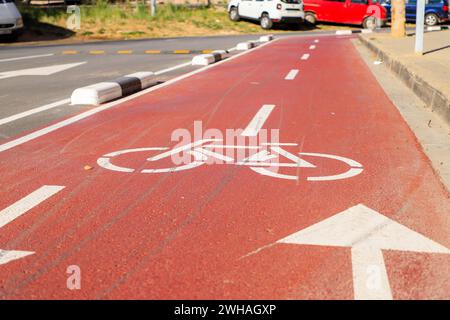 A bicycle lane ath on the road with directional arrows in Valencia Stock Photo