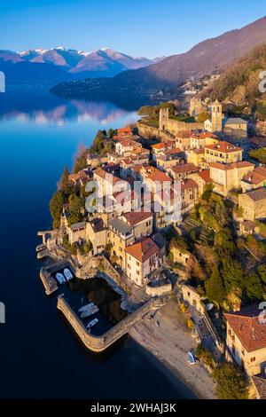 Aerial view at sunset in winter of the medieval village of Corenno Plinio. Dervio, Lake Como, Lecco province, Lombardy, Italy. Stock Photo