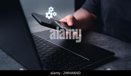 Woman updating system on smartphone. Software engineer and programming. Software apps developer. Stock Photo