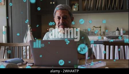 Image of data processing with digital financial icons over worried senior man using laptop Stock Photo