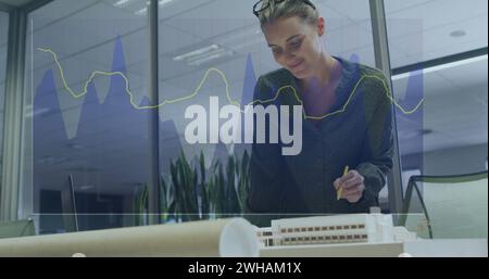 Image of financial data processing over biracial businesswoman Stock Photo