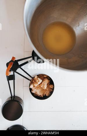 Melted butter, brown sugar in stainless steel - culinary magic Stock Photo