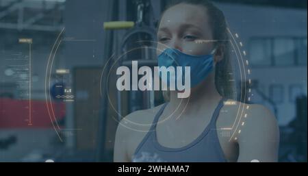 Image of covid-19 cell spinning over caucasian woman wearing face mask sneezing Stock Photo