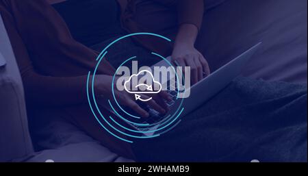 Image of cloud icon over hands using laptop in office Stock Photo