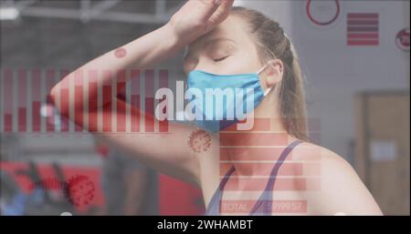 Coronavirus statistical data processing against woman wearing mask taking a break at the gym Stock Photo