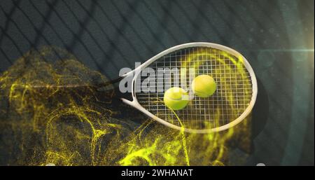 Image of glowing yellow particles over tennis balls on racket Stock Photo
