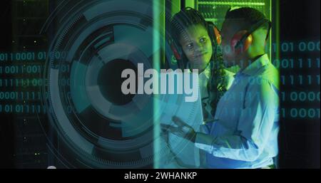 Image of data processing and binary coding over diverse it engineers and computer servers Stock Photo