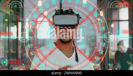 Data processing and scope scanning over african american man wearing vr headset at office Stock Photo
