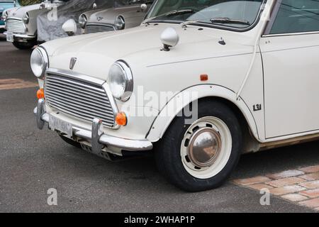 CHIBA, JAPAN -  February 3, 2023: Front of a Rover Mini Cooper 1.3i with other minis next to it at a specialist dealer's in Chiba Prefecture. Stock Photo