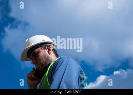 Engineer man talking on his phone in sunny day Stock Photo
