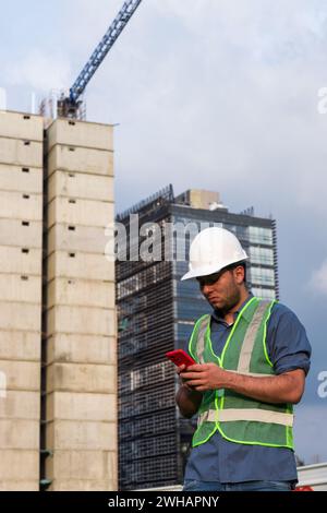 Engineer man working on his phone in construction site Stock Photo