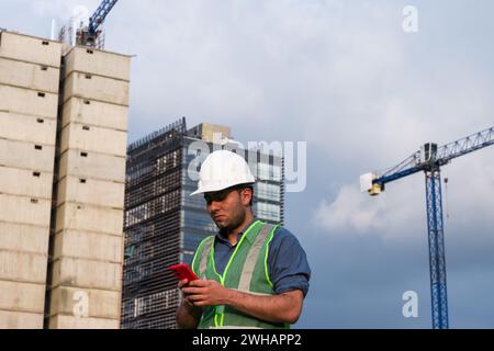 Engineer man working on his phone in construction site Stock Photo