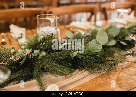 Simple wedding reception decor with eucalyptus & evergreen branches Stock Photo